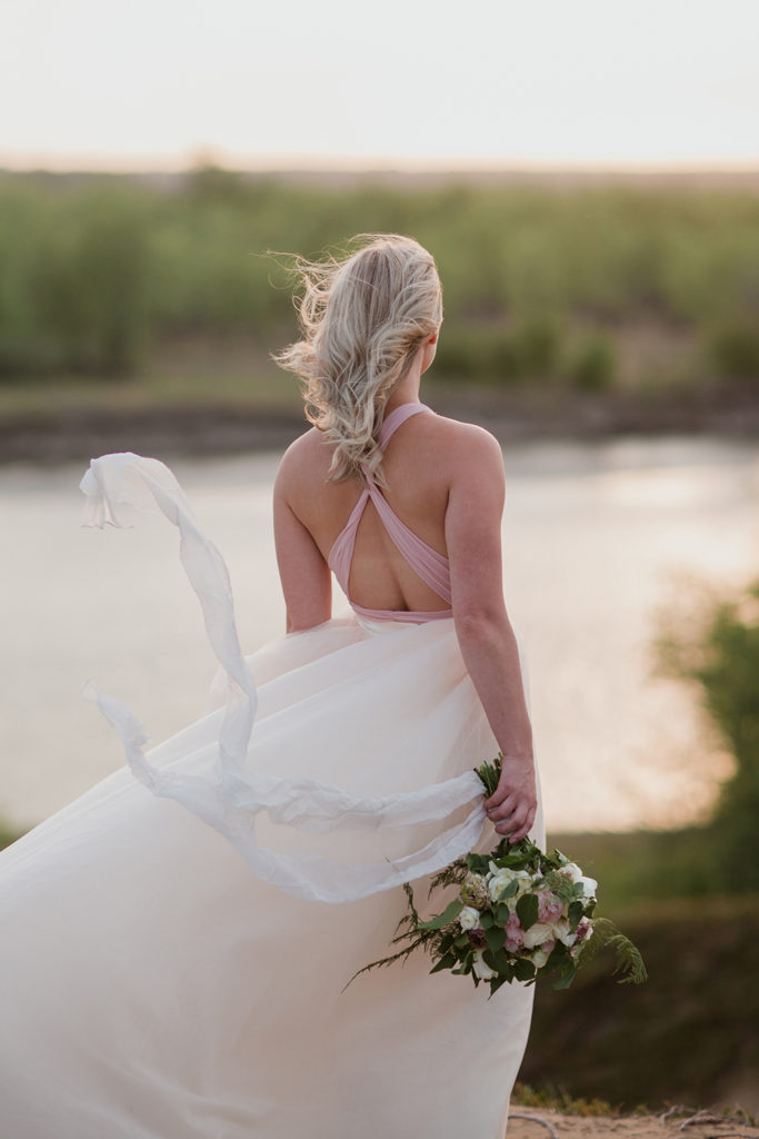 grin-back-to- camera-holding-flowers